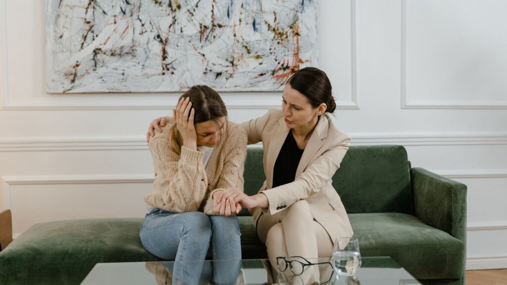 businesswoman being consoled by her coworker